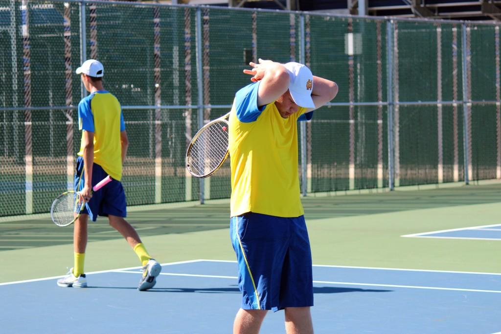 ________ walks back to serve as partner ________ regains his focus after the last play.