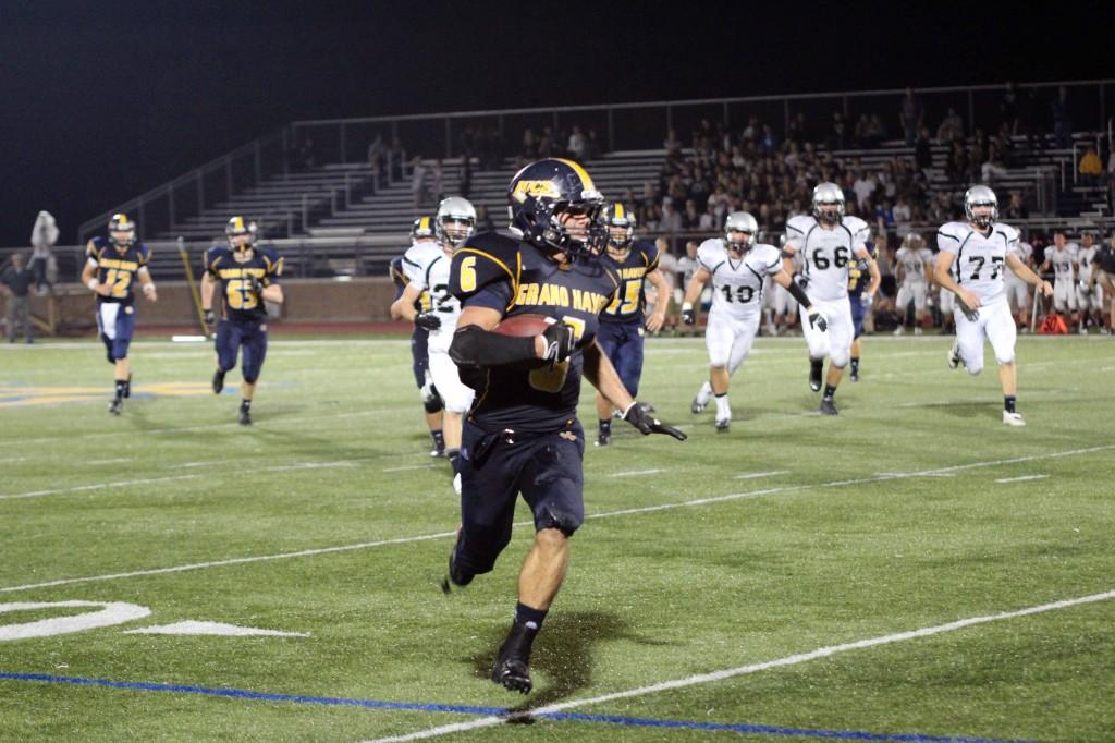Senior Abe Westerman (#6) sprints for a huge gain late in the game.  Westerman ran the ball 13 times for 121 yards for an average of 9.3 yards per carry.  (Carter)