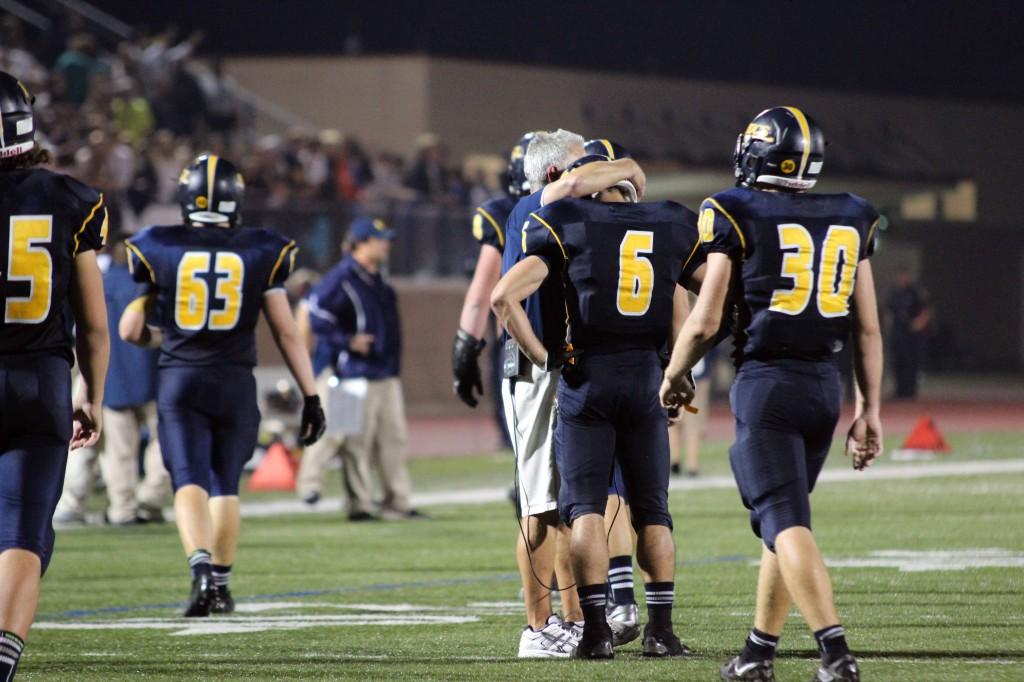 Westerman (#6) is consoled by assistant coach Dave Larkin after giving up the game losing fumble. (Hayes)