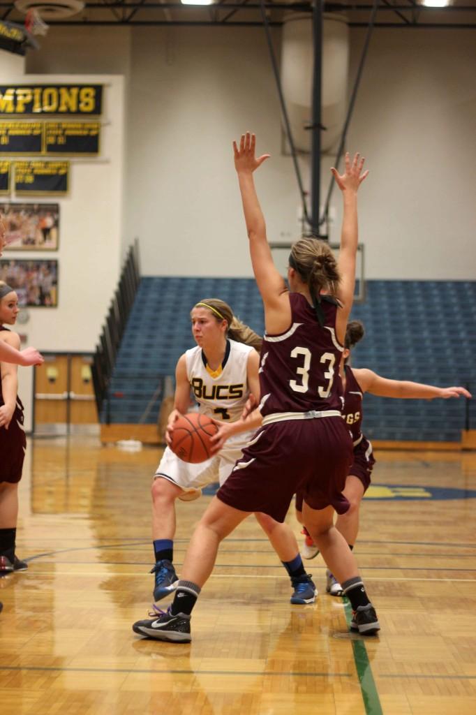 Junior Amanda Merz looking to pass the ball after being stopped by Grandvile Bulldog Lexie Berles.